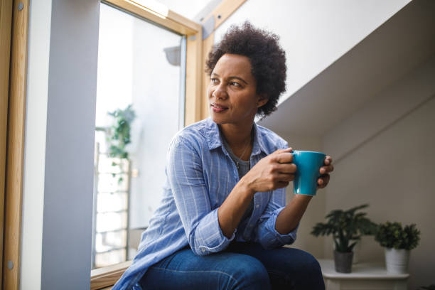 istock Enjoying a cup of coffee and contemplating while looking out the window 1402049389