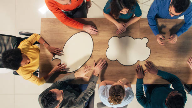 istock Business people having a meeting with blank thought bubbles placed on a conference table 1402049469