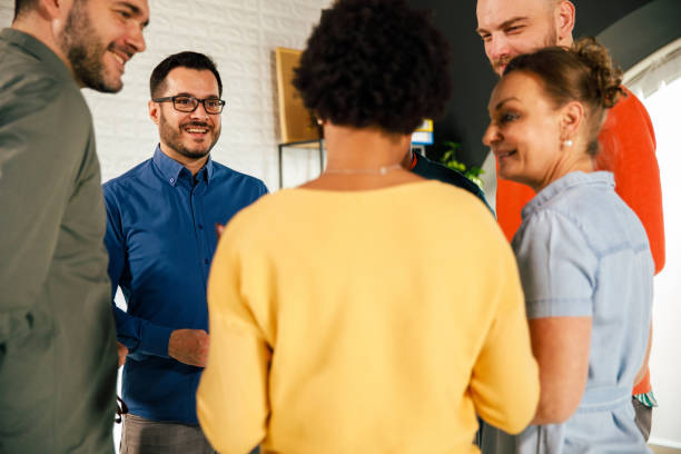 istock Group of people standing in a circle and engaging in casual conversation 1402049476