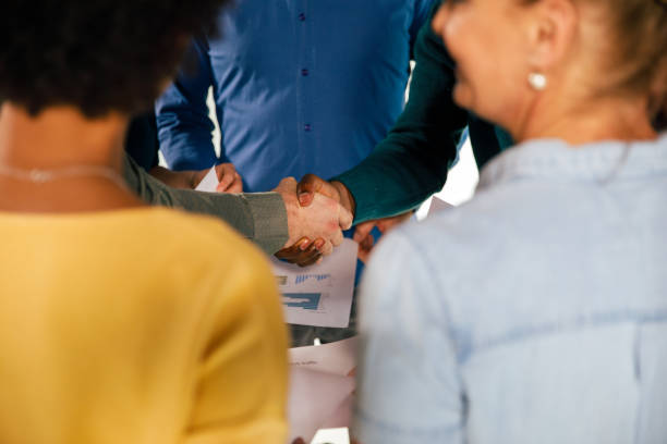 istock Unrecognizable business people shaking hands after coming to agreement 1402049480