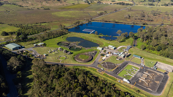 Aerial view of a sewage treatment plant in a leafy green natural environment
