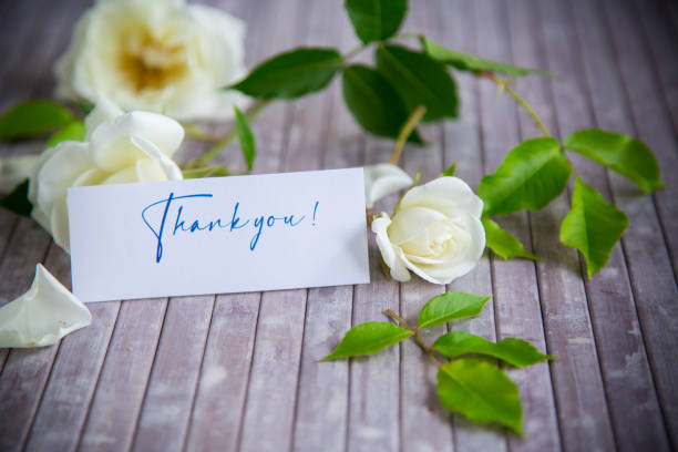 istock beautiful white summer roses, on a wooden table 1402052836