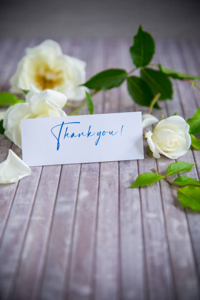 istock beautiful white summer roses, on a wooden table 1402052845