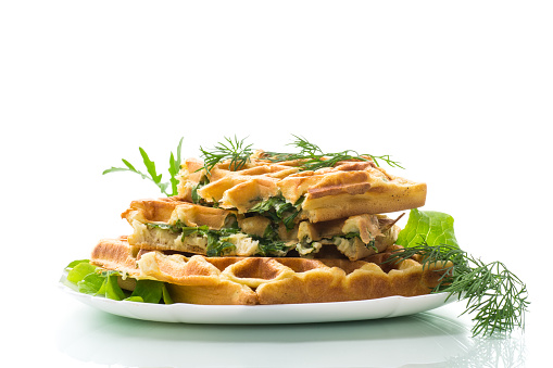 Homemade fried vegetable waffles with greens inside isolated on white background