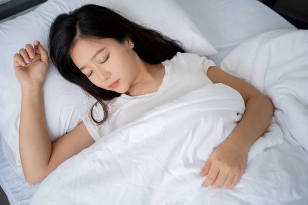 istock Woman is sleeping on a white bed. 1402053675