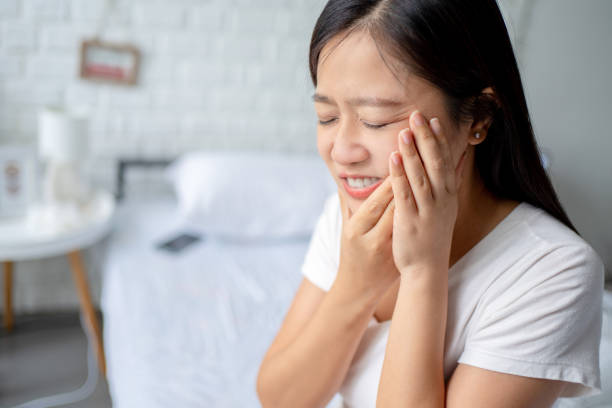 Woman feeling tooth pain. - https://media.istockphoto.com/id/1402053715/photo/beautiful-woman-feeling-tooth-pain.jpg?s=612x612&w=0&k=20&c=BamjfLUe6mRlQ7gq_9mn5kRr79daIaGSK8tzfMbat8k=