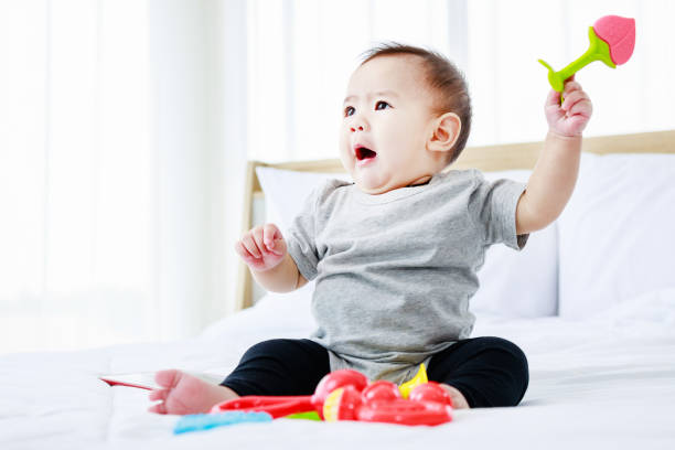 istock cute baby on bed. 8 months happy baby 1402053740