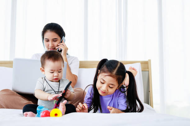 Asian Mother with baby daughter girl and baby using laptop home lifestyle Asian Mother with baby daughter girl and baby using laptop home lifestyle 6 9 months stock pictures, royalty-free photos & images