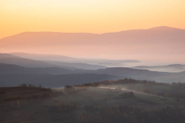 dawn cream mountains in the fog. Climate change from summer to autumn. dawn cream mountains in the fog. Climate change from summer to autumn. screen saver photos stock pictures, royalty-free photos & images