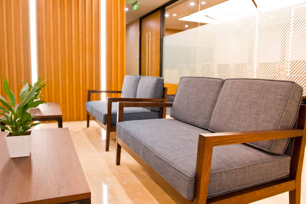 istock Office waiting area with sofa, armchairs, large wooden table 1402058165