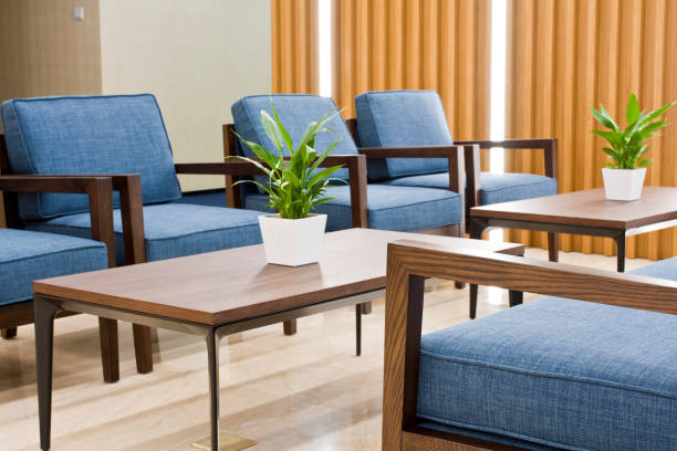 office waiting area with sofa, armchairs, large wooden table - airport waiting room waiting airport lounge imagens e fotografias de stock