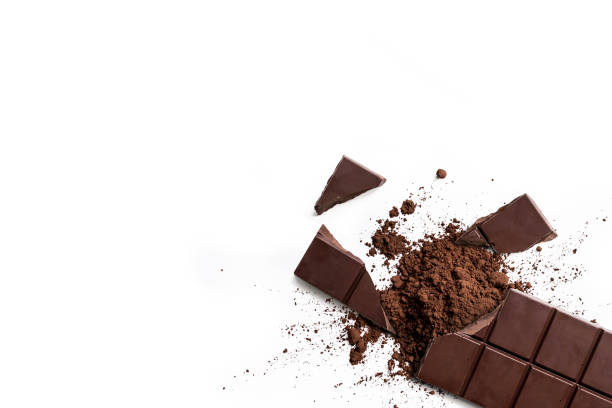 istock Broken organic dark chocolate bar and chocolate powder on isolated white background 1402058224