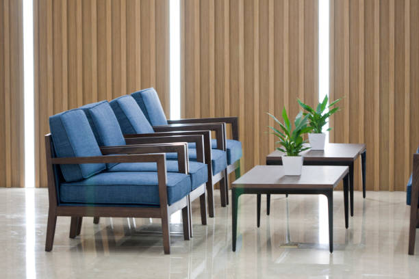 istock Office waiting area with sofa, armchairs, large wooden table 1402058225