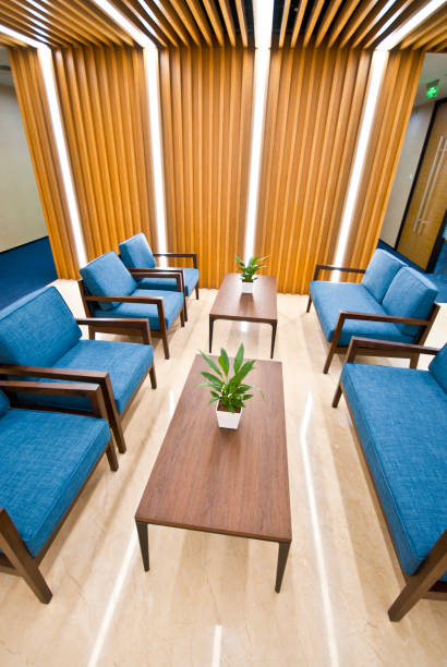 istock Office waiting area with sofa, armchairs, large wooden table 1402058247