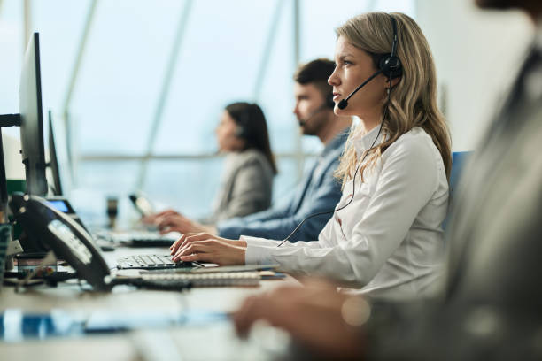 istock Female customer service representative working on PC in a call center. 1402058314