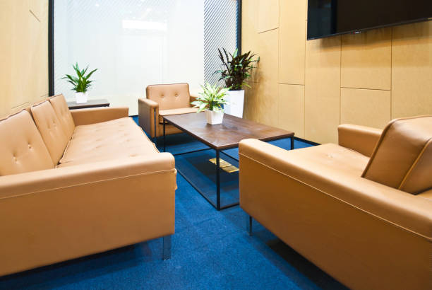 istock Lounge and reception area in modern office interior, tea table with comfortable sofa 1402058488