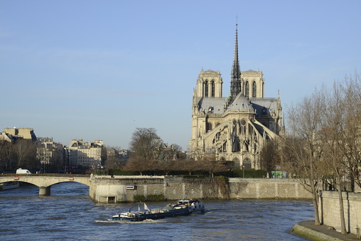 The tour boat over the bridge at Seine River and Eiffel Tower in Paris, France