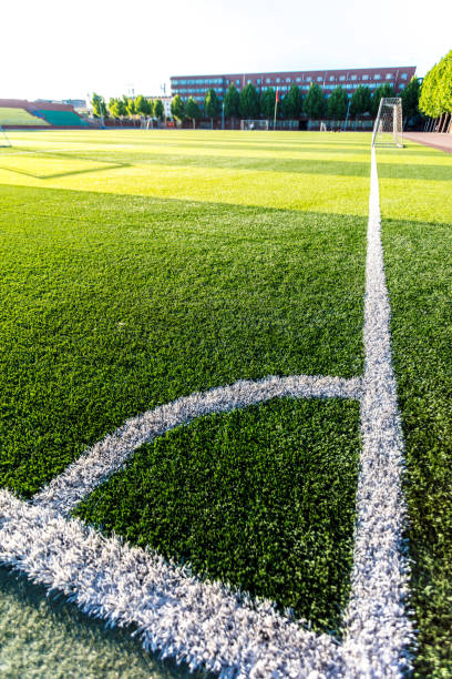 istock Football green grass field with corner white lines 1402067051