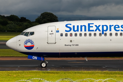 Manchester Airport, United Kingdom - 26 May, 2022: Sun Express Boeing 737 (Reg Unknown) taxiing towards T1 after landing.