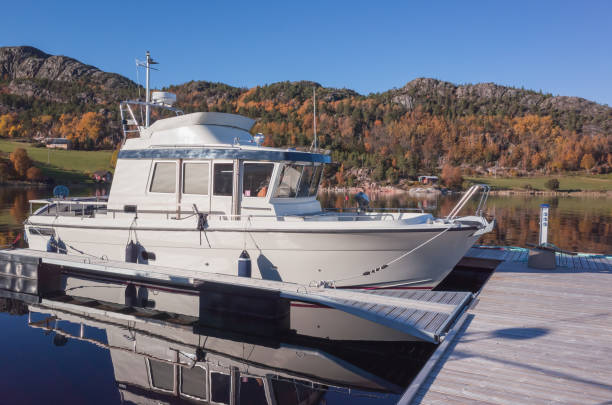 istock White motor boat is moored at floating pier 1402069890
