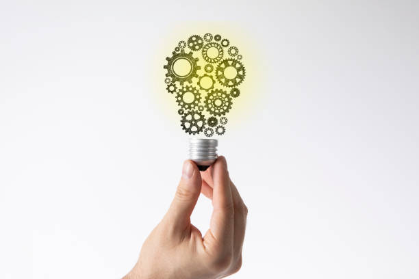 istock Hand Holding Light Bulb Made of Gears 1402075373