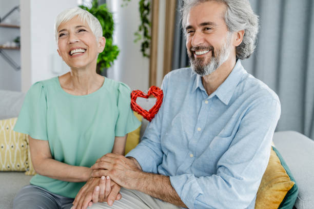 istock Happy senior laughing and holding hands 1402077678