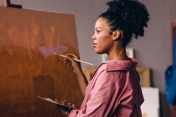 istock A Beautiful Mixed-race Professional Artist Painting In Her Studio Using A Paintbrush 1402082000