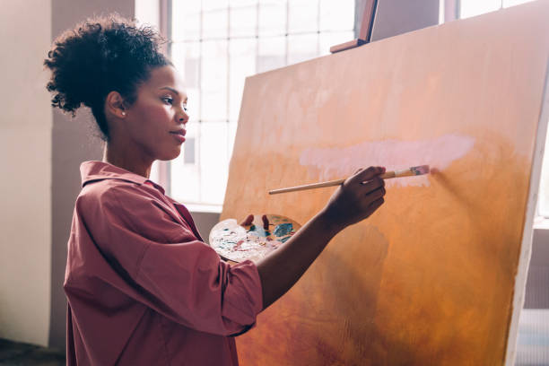 istock A Beautiful Devoted Mixed-race Professional Artist Painting In Her Studio Using A Paintbrush And Her Paint Palette 1402082013