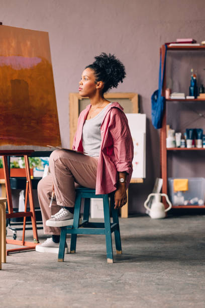 istock A Happy Beautiful Mixed-race Professional Artist Relaxing While Painting In Her Studio 1402082019