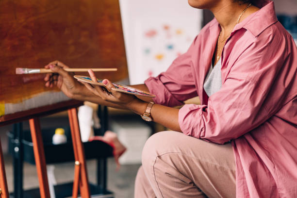 istock An Unrecognizable Mixed-race Professional Artist Painting In Her Studio Using A Paintbrush And Her Paint Palette 1402082032