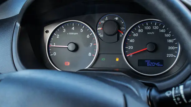 Photo of Gas gauge fuel empty. Petrol tank meter car indicator on dashboard. Low gasoline level. Fuel gauge gas.