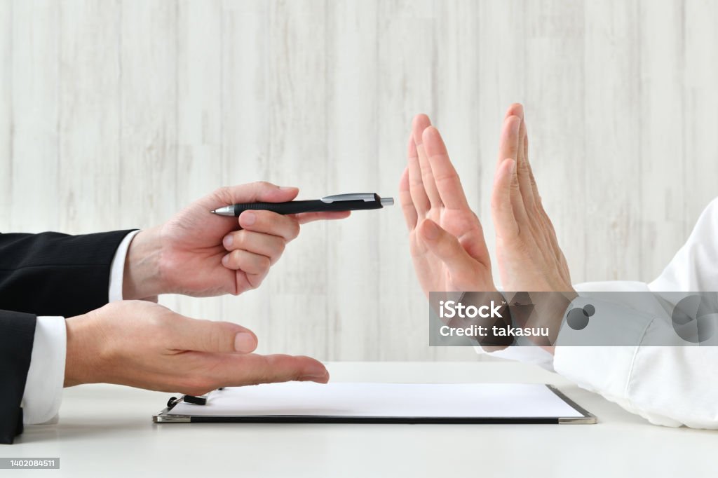 Business man recommending contract and customer refusing it Rebellion Stock Photo