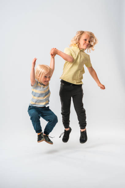 istock Two Caucasian Boys Jumping Off the Ground 1402084786