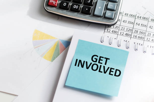 istock GET INVOLVED text on a blue card on notepad next to calculator and reports 1402085100