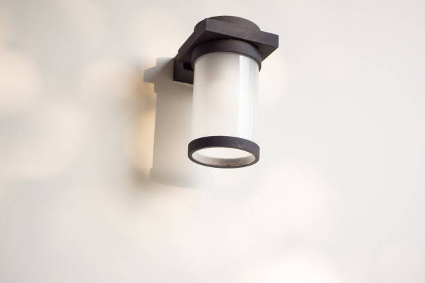 istock Outdoor cylinder lamp with tree leaves shadow on concrete wall 1402085872