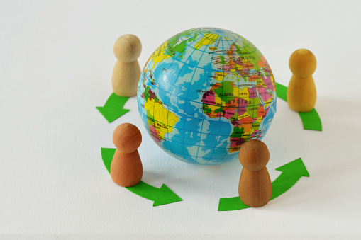 Pawns in a circle around earth glibe - Concept of globalization and teamwork