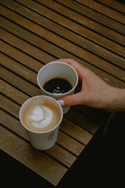 istock two cups of coffee. hand with cup of coffee 1402091323