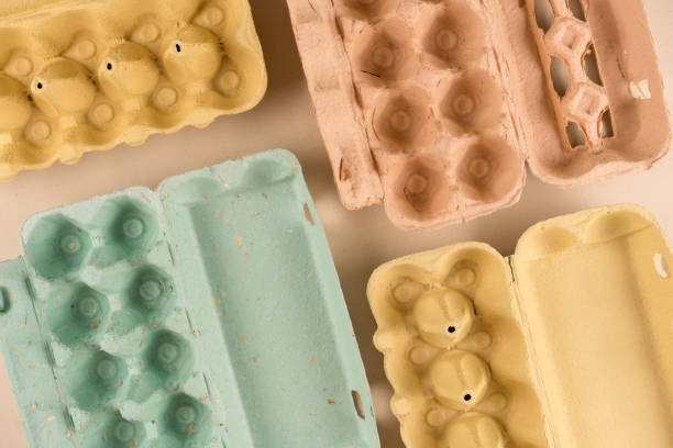 istock Different pulp egg cartons made with pulp and straw as background with copy space. Eco friendly egg boxes, sustainable food packaging concept. Flat lay, mockup 1402092511