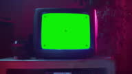 istock Close Up Footage of a Dated TV Set with Green Screen Mock Up Chroma Key Template Display. Nostalgic Retro Nineties Technology Concept. 1402092916