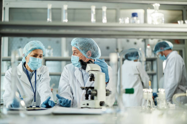 istock Two scientists talking while working on antiviral drug in laboratory. 1402095119