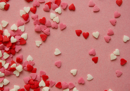 Multicolored background with candy hearts. Pink, white, red hearts. Love. Simovl love. Valentine is Day. Lots of small hearts. Flat. Copy space for text