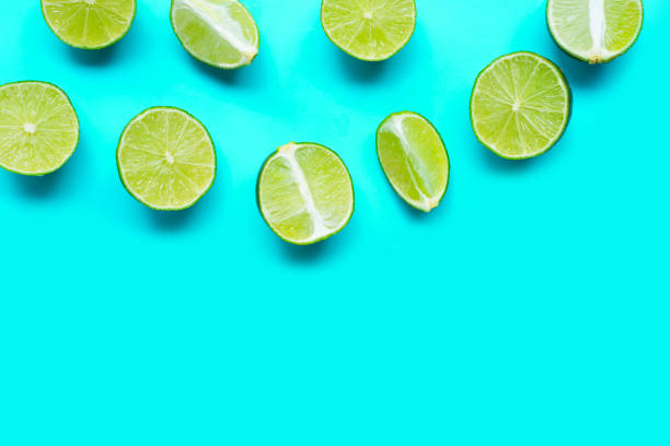 istock Fresh limes on blue background. top view 1402097294