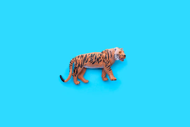 istock Tiger toys on blue background. 1402097406