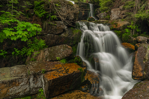 Waterfall of Jedlova creek in Jizerske mountains in spring cloudy morning