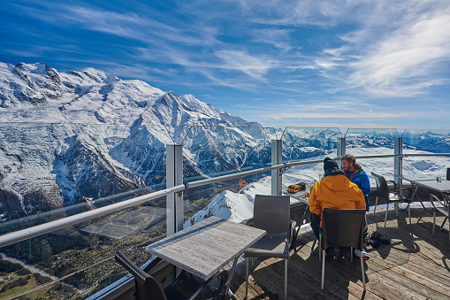 France, Chamonix Mont-Blanc - April 10, 2022: Tourists look at the French Alps and Mont-Blanc mountain from Le Brevent viewpoint, Chamonix-Mont-Blanc, France