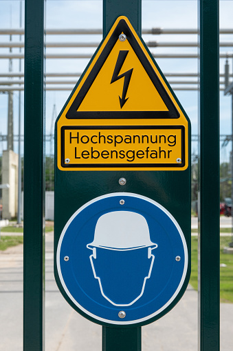 Caution high voltage Danger of death + wearing a helmet warning signs