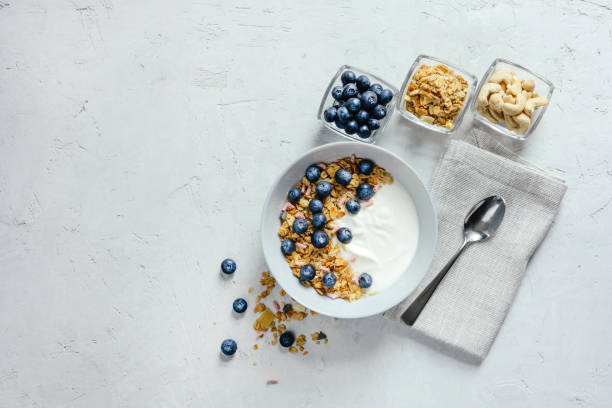 istock Yogurt with muesli and berries on a gray background. 1402099862