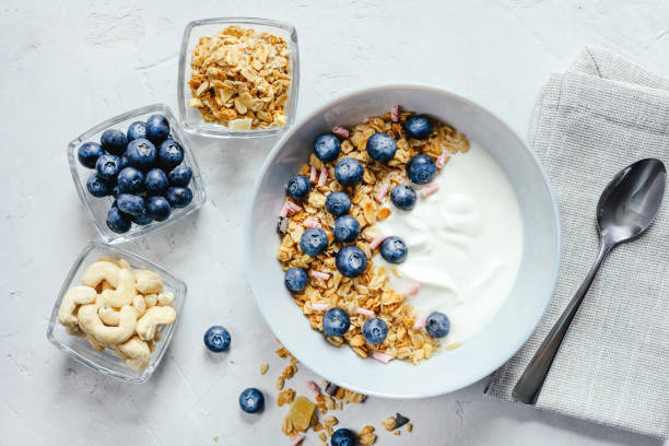 istock Yogurt with muesli and berries on a gray background. 1402099969