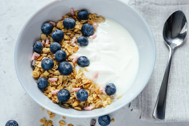 istock Yogurt with muesli and berries on a gray background. 1402100182