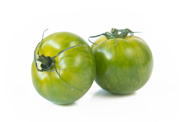 istock Green fresh tomatoes isolated on white background 1402101883